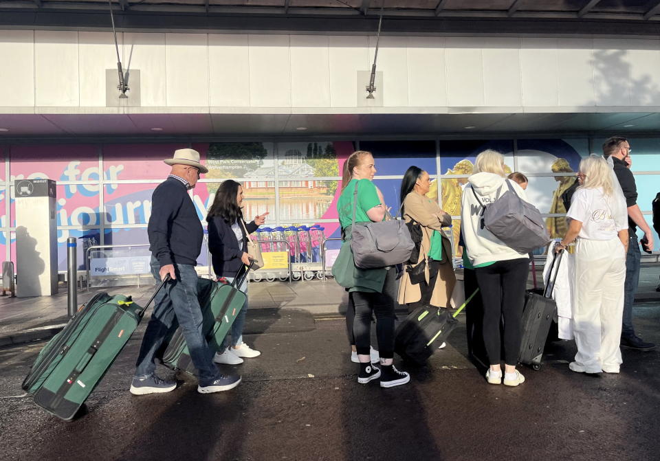 People queue outside Birmingham Airport on Friday amid confusion about hand luggage liquids rules. (SWNS)