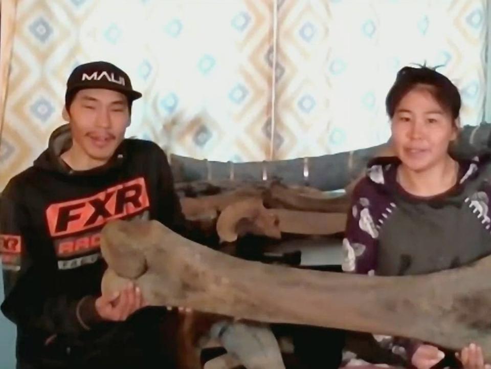 Joseph and Andrea Nassuk of Elim, Alaska with the mammoth bone they found on a walk (KTUU)