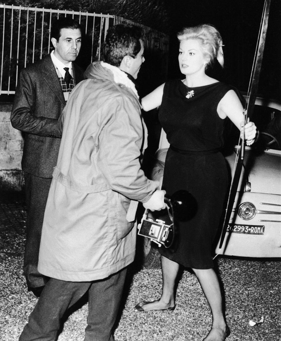 Ekberg attacking the paparazzi with a bow and arrow, Rome, October 1960 - AP