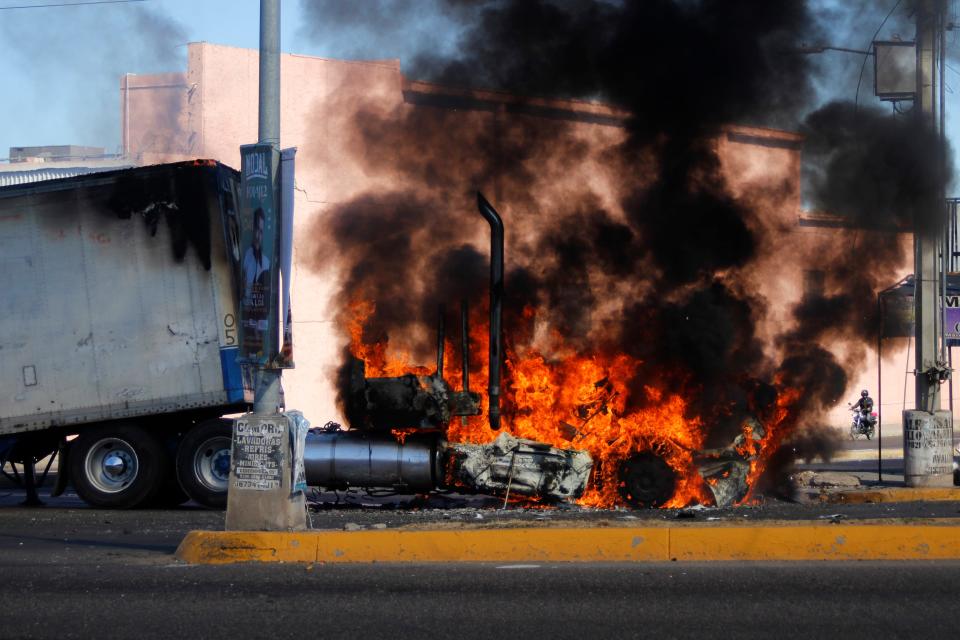 A truck burns on a street in Culiacan, Mexico, on Jan. 5, 2023. Mexican security forces captured Ovidio Guzmán, son of the infamous Sinaloa drug lord known as "El Chapo," in a predawn operation.