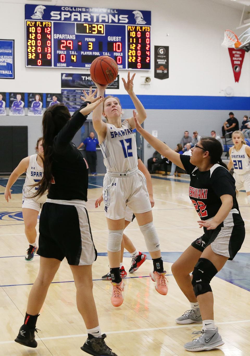 Collins-Maxwell's Marissa Boege takes a shot in the lane against the defense of Meskwaki's Irene Keahna (11) and Sophie Balderas during the second quarter of the Spartans' 53-20 victory over the Warriors in the Class 1A regional first round Feb. 9 at Maxwell. Boege had 8 points in the win.