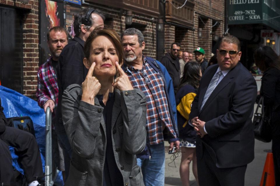 Comedian Tina Fey pretends to cry as she arrives at Ed Sullivan Theater in Manhattan as David Letterman prepares for the taping of tonight's final edition of "The Late Show" in New York