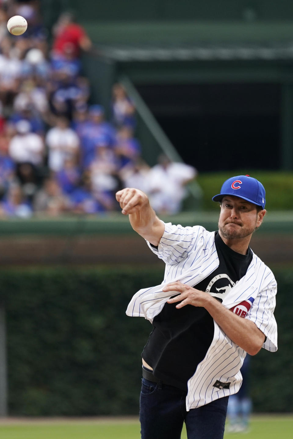 Former NASCAR champion Kurt Busch throws out a ceremonial first pitch before a baseball game between the Boston Red Sox and the Chicago Cubs in Chicago, Friday, July 1, 2022. (AP Photo/Nam Y. Huh)