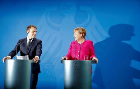 FILE PHOTO: German Chancellor Angela Merkel and French President Emmanuel Macron address a news conference at the Chancellery in Berlin, Germany, May 15, 2017. REUTERS/Fabrizio Bensch/File Photo