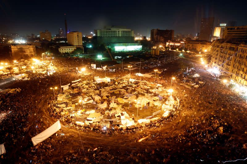 FILE PHOTO: Anti-government protesters in Cairo's Tahrir Square listen as President Hosni Mubarak speaks to the nation