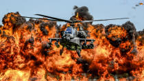 <p>An AH-64D Apache attack helicopter flies in front of a wall of fire during the South Carolina National Guard Air and Ground Expo at McEntire Joint National Guard Base, South Carolina, U.S. on May 6, 2017. Picture taken on May 6, 2017. (Photo: Jorge Intriago/Courtesy Air National Guard/Reuters) </p>