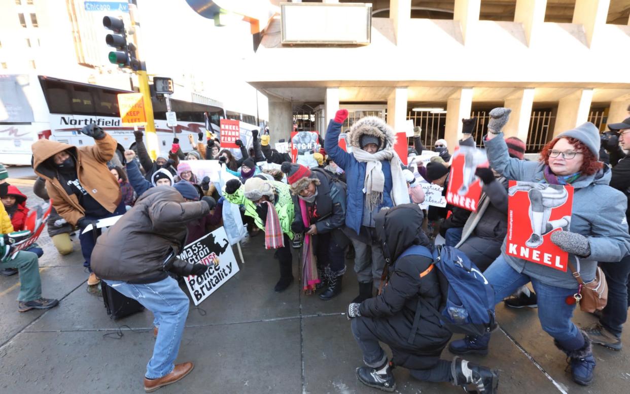 Protesters take a knee near the stadium before the Super Bowl - REUTERS