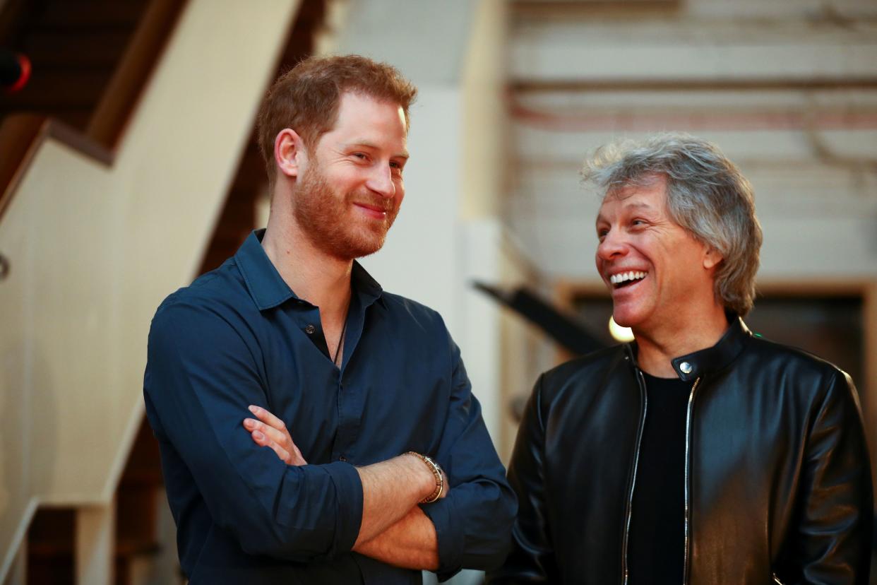 Britain's Prince Harry, Duke of Sussex (L) and US singer Jon Bon Jovi gesture at Abbey Road Studios in London on February 28, 2020, where they met with members of the Invictus Games Choir, who were there to record a special single in aid of the Invictus Games Foundation. (Photo by HANNAH MCKAY / POOL / AFP) (Photo by HANNAH MCKAY/POOL/AFP via Getty Images)