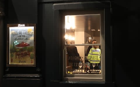 Police inside a Zizzi restaurant in Castle Street, Salisbury, which has been closed in connection with the incident  - Credit: Steve Parsons/PA 