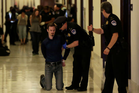 A healthcare activist is detained after a protest to stop the Republican health care bill at Russell Senate Office Building on Capitol Hill. REUTERS/Yuri Gripas