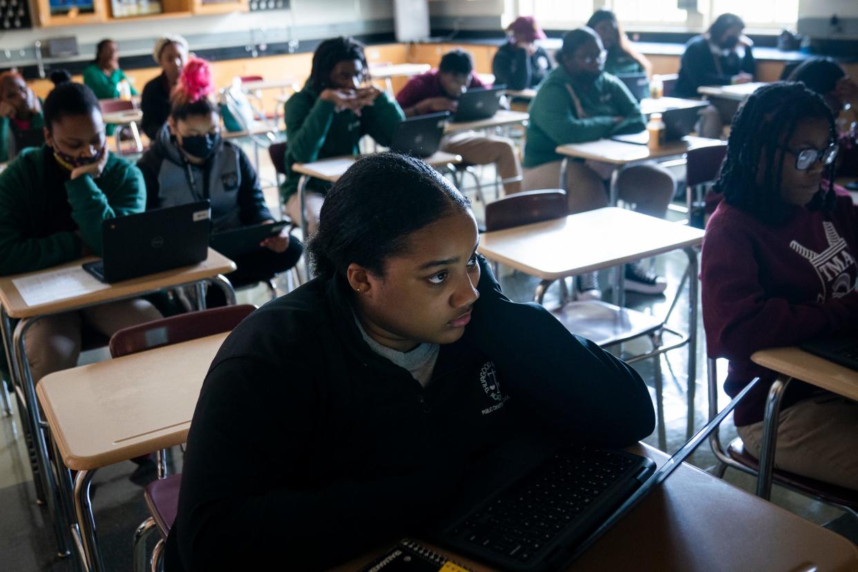 Raniya Ball, a senior at Thurgood Marshall Academy Public Charter High School, and classmates watch their instructor Rachel Pomeroy, on screen, during class in May.