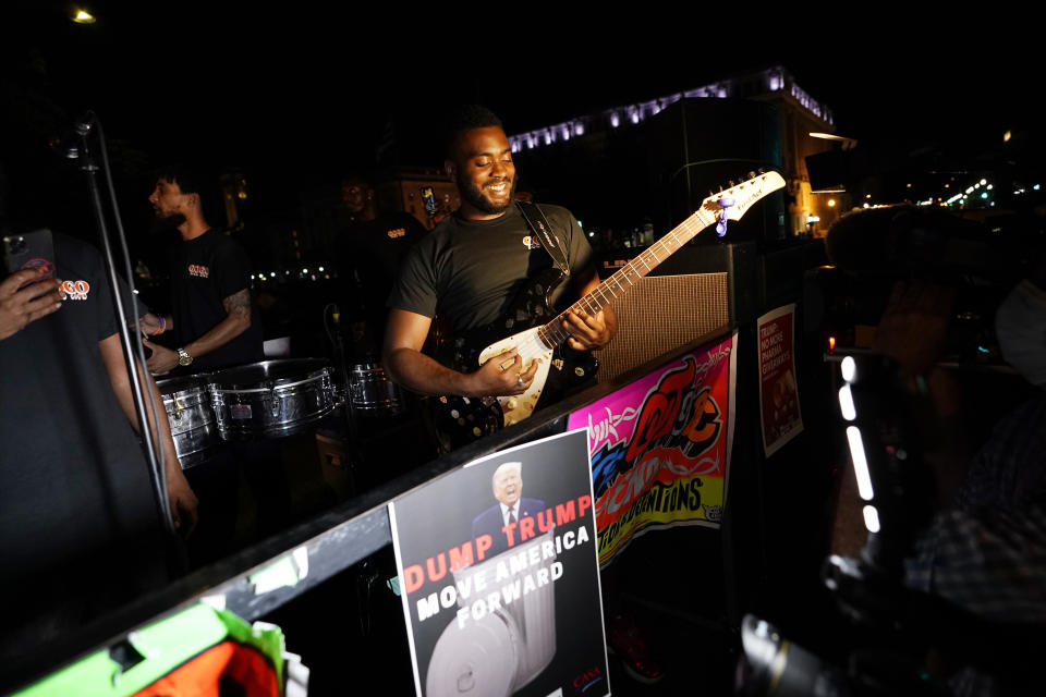 The Shutdown D.C. Band, on the back of a flatbed truck, plays near the White House in Washington, Thursday, Aug. 27, 2020. President Donald Trump is set to deliver his outdoor acceptance speech later Thursday night from the White House South Lawn.(AP Photo/Carolyn Kaster)