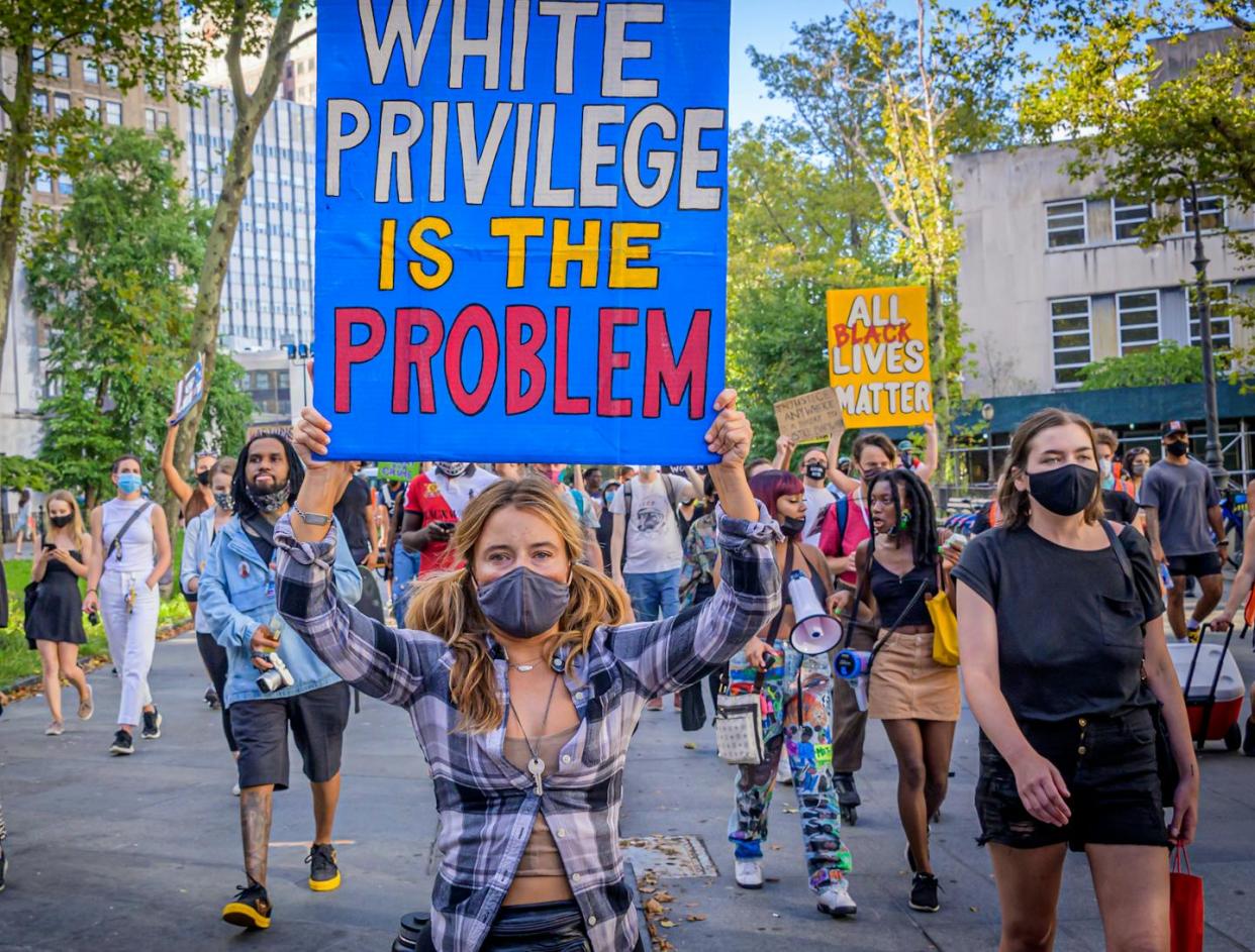A protester holds a sign reading 'White Privilege Is The Problem' at a rally against policy brutality and racial injustice in New York on Sept. 5, 2020. <a href="https://www.gettyimages.com/detail/news-photo/participant-holding-a-white-privilege-is-the-problem-sign-news-photo/1228367837?adppopup=true" rel="nofollow noopener" target="_blank" data-ylk="slk:Erik McGregor/LightRocket via Getty Images;elm:context_link;itc:0;sec:content-canvas" class="link ">Erik McGregor/LightRocket via Getty Images</a>