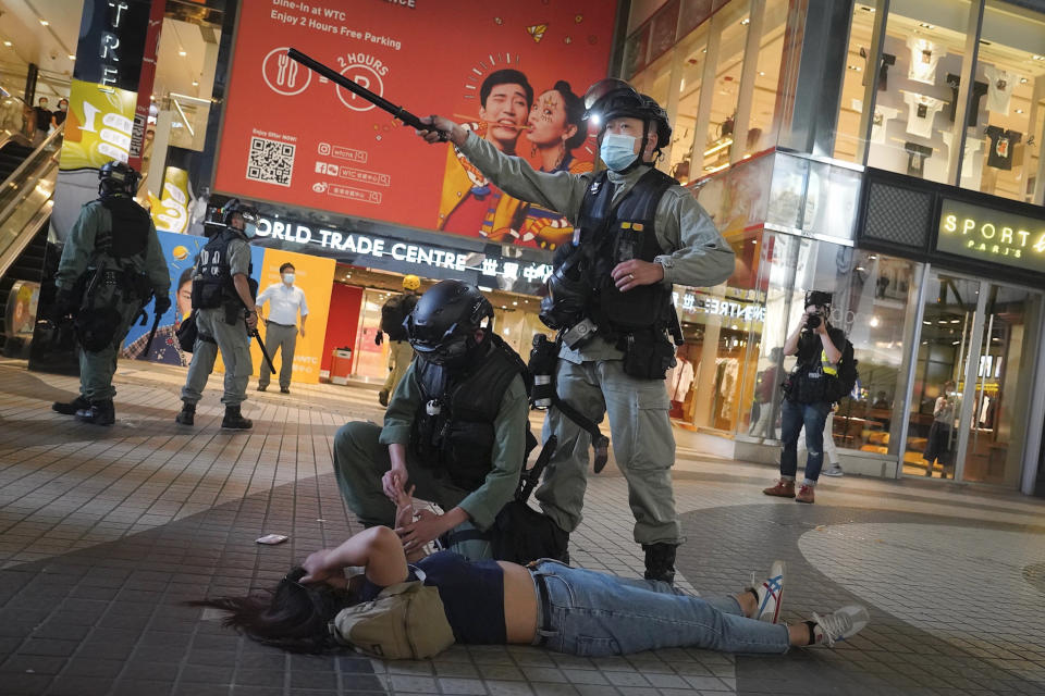 Hong Kong Riot police detain a protester during a protest in Causeway Bay, Hong Kong, Friday, June 12, 2020. Protesters in Hong Kong got its government to withdraw extradition legislation last year, but now they're getting a more dreaded national security law, and the message from Beijing is that protest is futile. (AP Photo/Vincent Yu)