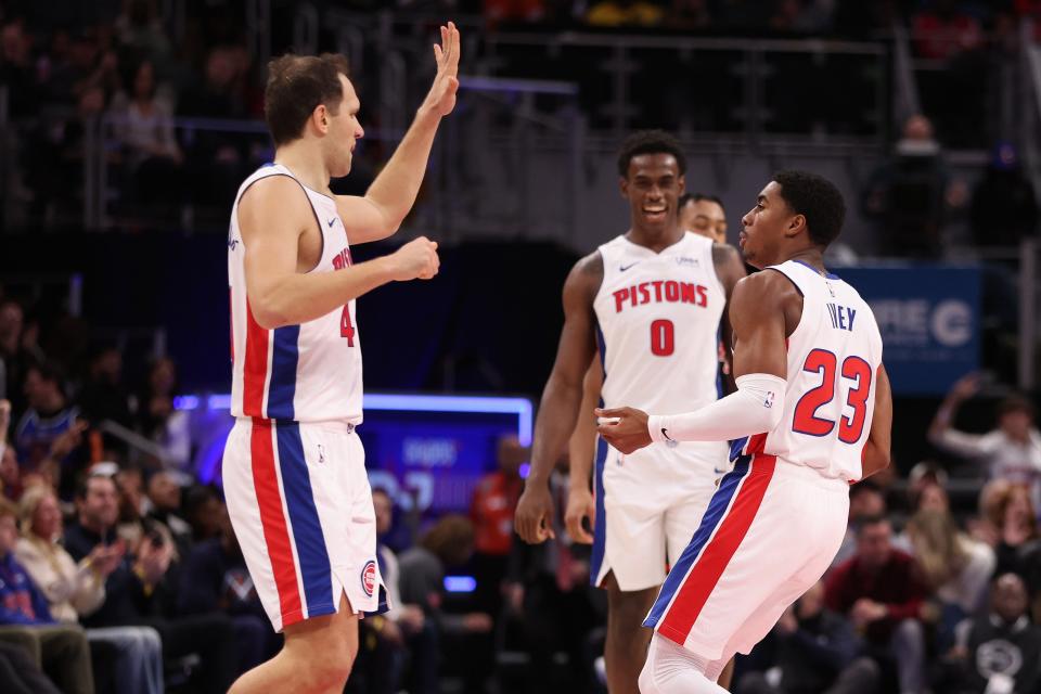 Pistons guard Jaden Ivey, right, celebrates a 3-point basket with Bojan Bogdanovic, left, in the second half of the Pistons' 129-127 win over the Raptors on Saturday, Dec. 30, 2023, at Little Caesars Arena, snapping the Pistons' 28-game losing streak.