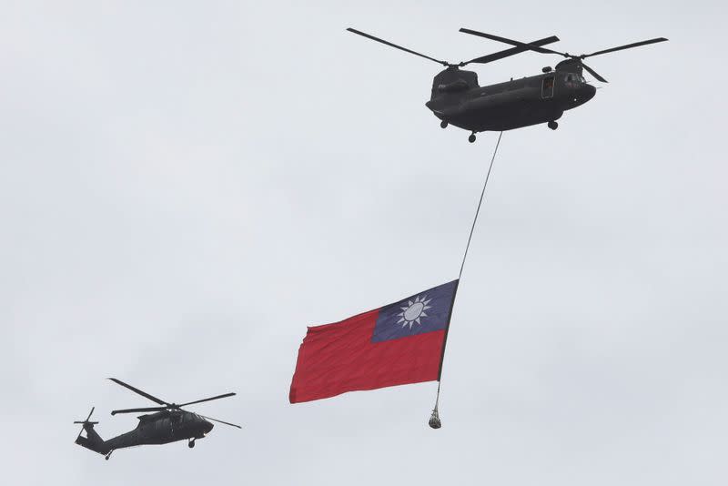 A Taiwan flag flews across the sky during National Day celebrations in Taipei