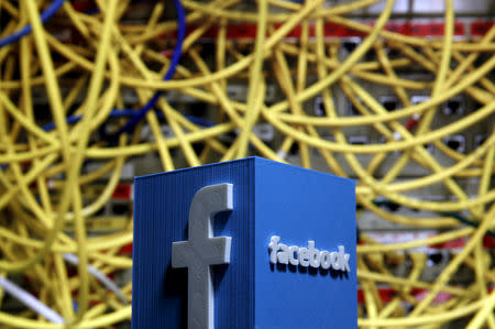 FILE PHOTO: A 3D plastic representation of the Facebook logo is seen in front of displayed cables in this illustration in Zenica, Bosnia and Herzegovina May 13, 2015. REUTERS/Dado Ruvic/File Photo