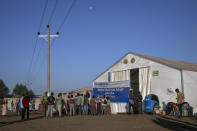 Tigray refugees who fled the conflict in the Ethiopia's Tigray wait in line at the registration point at Hamdeyat Transition Center near the Sudan-Ethiopia border, eastern Sudan, Thursday, Dec. 3, 2020. Ethiopian forces on Thursday blocked people from the country's embattled Tigray region from crossing into Sudan at the busiest crossing point for refugees, Sudanese forces said.(AP Photo/Nariman El-Mofty)