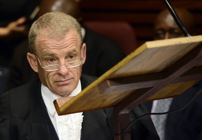 South African prosecutor Gerrie Nel attends the bail hearing of South African Olympic sprinter Oscar Pistorius at the Magistrate Court in Pretoria on February 19, 2013. Nel told the court Pistorius had armed himself, put on his prosthetic legs, walked seven metres and fired four shots into the bathroom door, hitting his terrified girlfriend three times and fatally wounding her