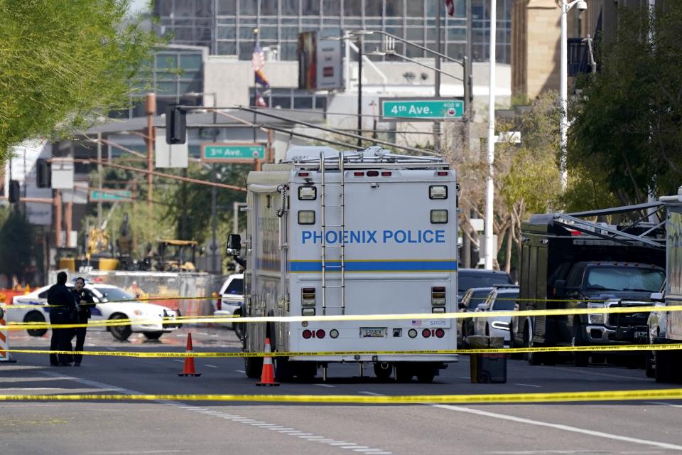 The Phoenix Police Department close off a street during an investigation outside the Sandra Day O'Connor U.S. Courthouse in Phoenix, on Tuesday, Sept. 15, 2020. A drive-by shooting wounded a federal court security officer Tuesday outside the courthouse in downtown Phoenix, authorities said. The officer was taken to a hospital and is expected to recover, according to city police and the FBI, which is investigating. (AP Photo/Ross D. Franklin)