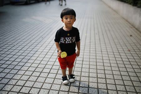 Ma Chenxi, who was born in 2011, poses for a photograph in Shanghai August 22, 2014. REUTERS/Carlos Barria