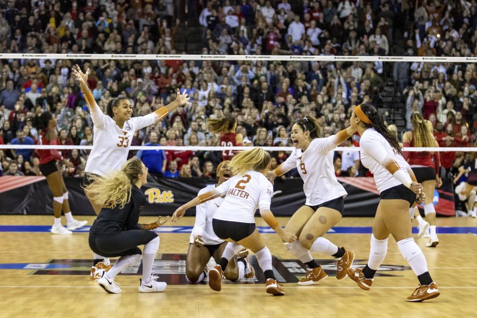 Texas players rush the court to dogpile in celebration of their national championship victory Saturday night. “Jerritt (Elliott, UT's coach) surrounded us with great people who wanted to be here and who are just great individuals and committed to the same goal,” AVCA national player of the year Logan Eggleston said.
