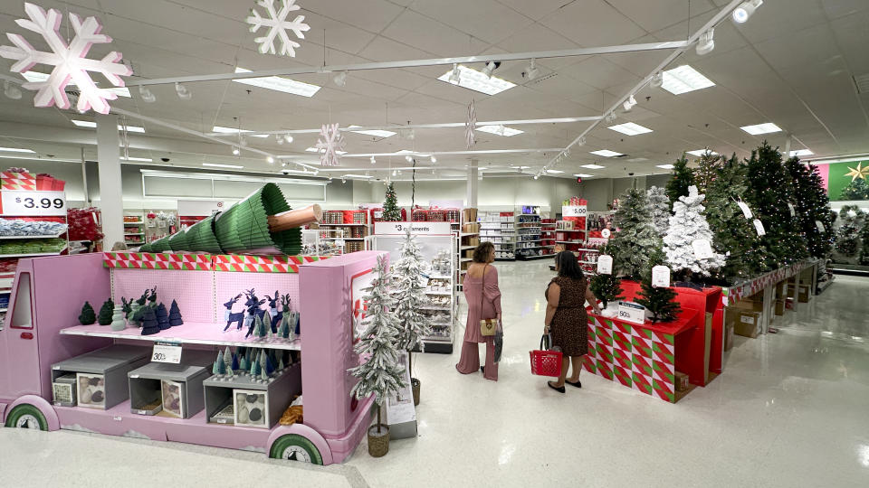 Shoppers look over holiday merchandise on display at a Target store Wednesday, Nov. 15, 2023, in Orlando, Fla. Retailers are kicking off the unofficial start of the holiday shopping season on Friday with a bevy of discounts and other enticements. (AP Photo/John Raoux)