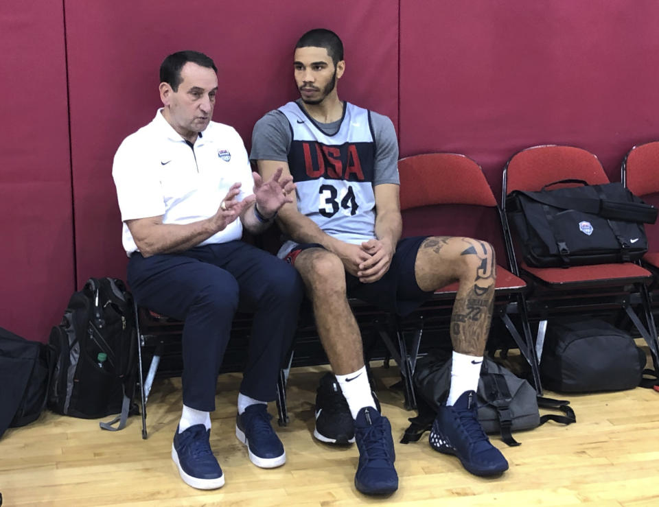 Former USA Basketball coach Mike Krzyzewski talks with Boston Celtics forward Jayson Tatum after the U.S. training camp practice Wednesday, Aug. 7, 2019, in Las Vegas. Tatum played for Krzyzewski at Duke. Krzyzewski is in Las Vegas for a couple days to show support to new USA coach Gregg Popovich and his staff as they prepare for the FIBA World Cup in China. (AP Photo/Tim Reynolds)