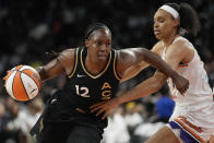 Las Vegas Aces guard Chelsea Gray (12) drives arouns Phoenix Mercury forward Brianna Turner (21) during the first half in Game 1 of a WNBA basketball first-round playoff series Wednesday, Aug. 17, 2022, in Las Vegas. (AP Photo/John Locher)