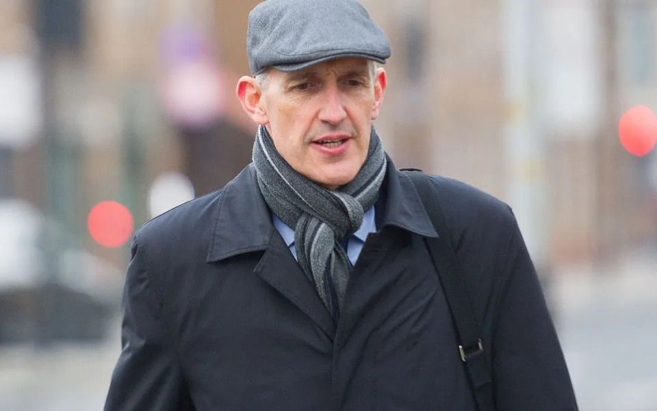 Mr Bretherton in flat cap and scarf outside court - Nicholas Razzell