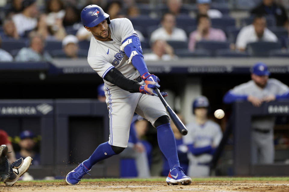 Toronto Blue Jays' George Springer hits an RBI single during the second inning of the team's baseball game against the New York Yankees on Thursday, Aug. 18, 2022, in New York. (AP Photo/Adam Hunger)