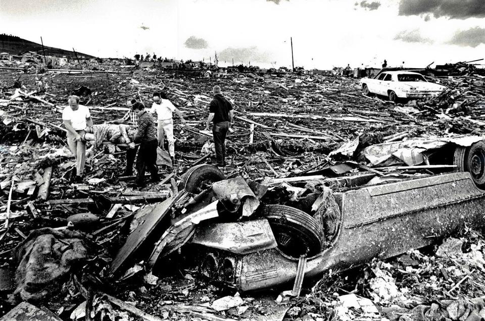 Residents looked through the devastation done near Burnett's Mound by Topeka's 1966 tornado.