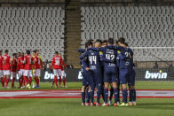 Belenenses' players gather together on the pitch at the start of the Portuguese Primeira Liga soccer match between Belenenses SAD and SL Benfica, Saturday, Nov. 27, 2021. Belenenses SAD started the match with only nine players due to a coronavirus outbreak. Portuguese health authorities on Monday, Nov. 29, 2021, identified 13 cases of omicron, the new coronavirus variant spreading fast globally, among members of Belenenses SAD. (AP Photo/Pedro Rocha)