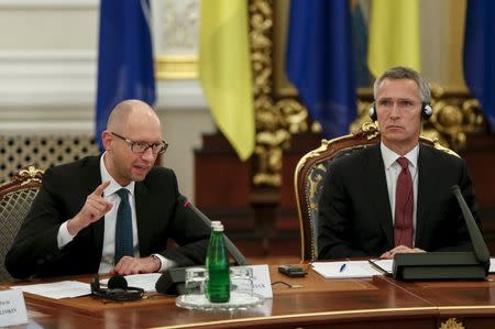 Ukrainian Prime Minister Arseny Yatseniuk (L) and NATO Secretary-General Jens Stoltenberg attend the meeting of national security and defense council of Ukraine in Kiev September 22, 2015. REUTERS/Gleb Garanich