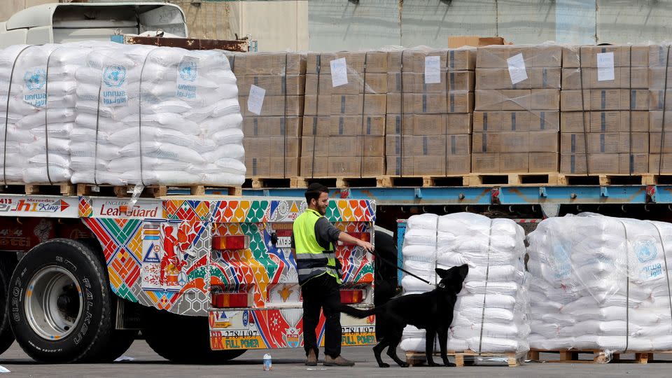 Aid shipments slated for Gaza are sniffed by a dog at the Kerem Shalom border crossing on March 14, 2024. - Jack Guez/AFP/Getty Images