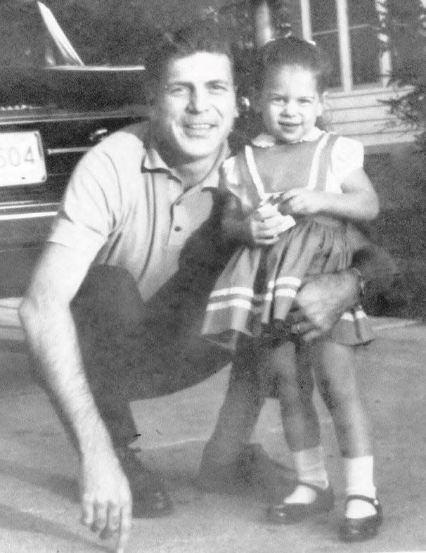 Gerald Meyers, former CEO of American Motors Corp., with his daughter, Susan Meyers, age 5, in the driveway of their home in Huntington Woods circa 1963.