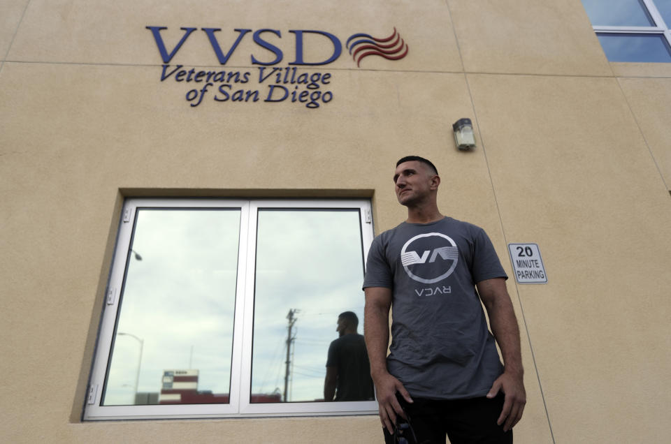 Marine veteran Shaun Tullar poses for a portrait in front of the Veterans Village of San Diego Thursday, Nov. 1, 2018, in San Diego. The number of homeless veterans across the U.S. declined more than 5 percent over the past year after a slight rise in 2017, the departments of Housing and Urban Development and Veterans Affairs announced Thursday. Tullar spent a time homeless, cycling in and out of jail on drug charges until finding help through a program behind bars that connected him with the VA. He now lives at Veterans Village of San Diego, is sober and working toward finishing a college degree. (AP Photo/Gregory Bull)
