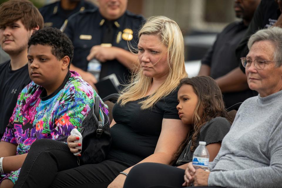 Kristine Courts, center, sits with her son Darian Courts, 15, left and her daughter Devyn Courts, 9, during a vigil to honor her husband and their father, fallen officer Loren Courts during at the Detroit Police Department's Second Precinct on July 15, 2022. Over 200 people showed up to the Second Precinct Detroit Police Department's vigil this afternoon in honor of her late father, Loren Courts, 40, who was killed in the line of duty last week.