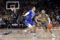 Marquette's Markus Howard (0) drives to the basket against Creighton's Marcus Zegarowski (11) during the first half of an NCAA college basketball game Tuesday, Feb. 18, 2020, in Milwaukee. (AP Photo/Aaron Gash)