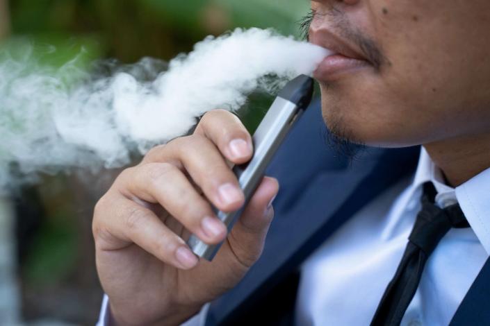 PHOTO: Young male worker smoking electronic cigarette (Stock photo) (Seksan Mongkhonkhamsao/Getty Images)