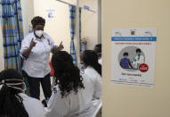 Medical staff wait in line to receive some of the country's first coronavirus vaccinations using AstraZeneca COVID-19 vaccine manufactured by the Serum Institute of India and provided through the global COVAX initiative, at Kenyatta National Hospital in Nairobi, Kenya Friday, March 5, 2021. Urgent calls for COVID-19 vaccine fairness rang through African countries on Friday as more welcomed or rolled out doses from the global COVAX initiative, with officials acutely aware their continent needs much more. (AP Photo/Ben Curtis)