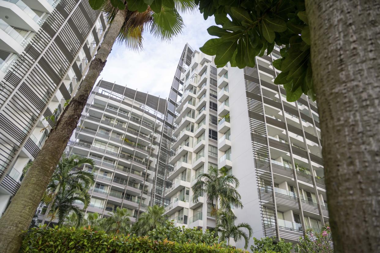 Modern residential area in Singapore. People live in small compact smart home apartments close to the neighbour. This aerial view shows the Sentosa Cove area in the southern tip of Singapore.