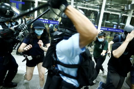 Police clash with anti-government protesters at the airport in Hong Kong,