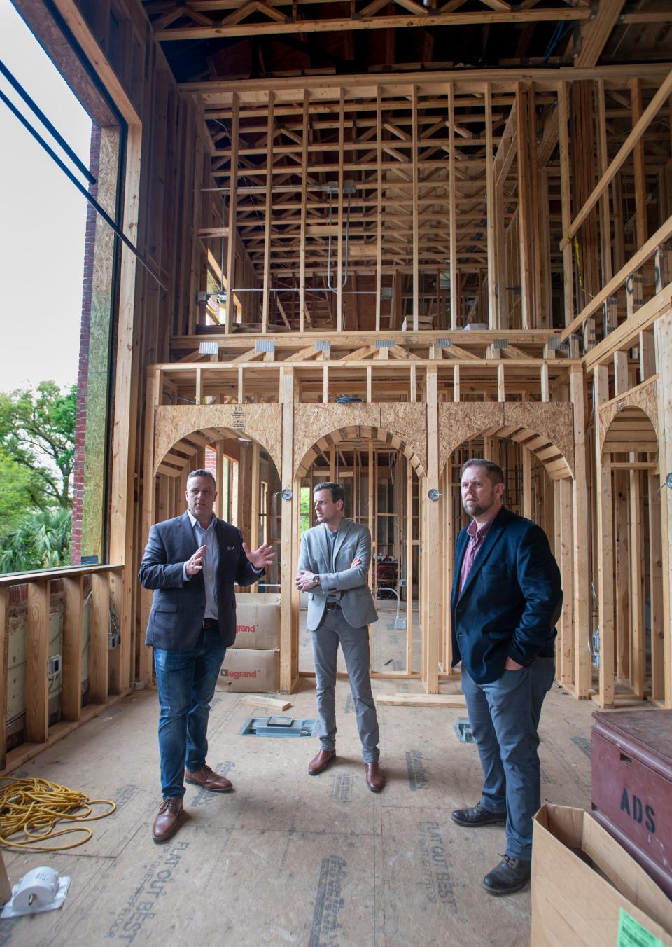 From left, Stahlman Hospitality development partners Nathan Weinberg, Troy Staghouse and Steve Mabee give a tour of the parlor in the Lily Hall development under construction in downtown Pensacola on Wednesday.