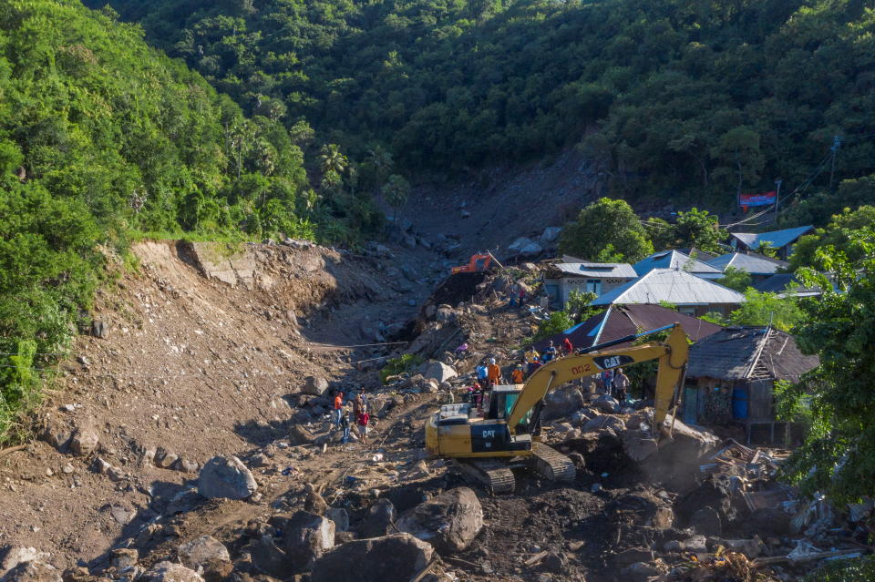 An aerial picture shows an excavator search for a body at an area affected by landslides triggered by tropical cyclone Seroja in Lembata, East Nusa Tenggara province, Indonesia.