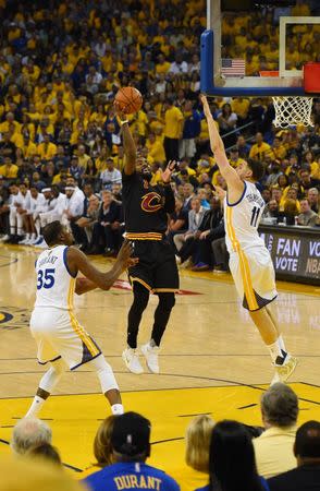 Jun 4, 2017; Oakland, CA, USA; Cleveland Cavaliers guard Kyrie Irving (2) shoots against Golden State Warriors guard Klay Thompson (11) and forward Kevin Durant (35) during the first half in game two of the 2017 NBA Finals at Oracle Arena. Mandatory Credit: Kyle Terada-USA TODAY Sports