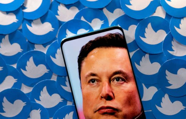 PHOTO: An image of Elon Musk is seen on a smartphone placed on printed Twitter logos in this picture illustration taken April 28, 2022. (Dado Ruvic/Reuters,FILE )