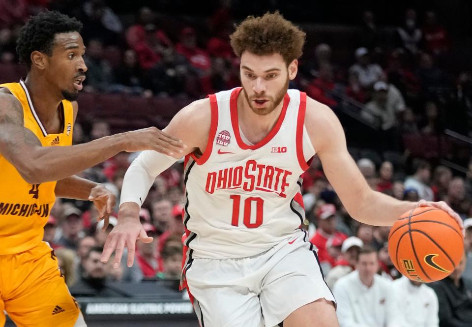 Nov 29, 2023; Columbus, OH, USA; Ohio State Buckeyes forward Jamison Battle (10) is guarded by Central Michigan Chippewas forward Jemal Davis (4) in the second half of their game at at the Schottenstein Center.