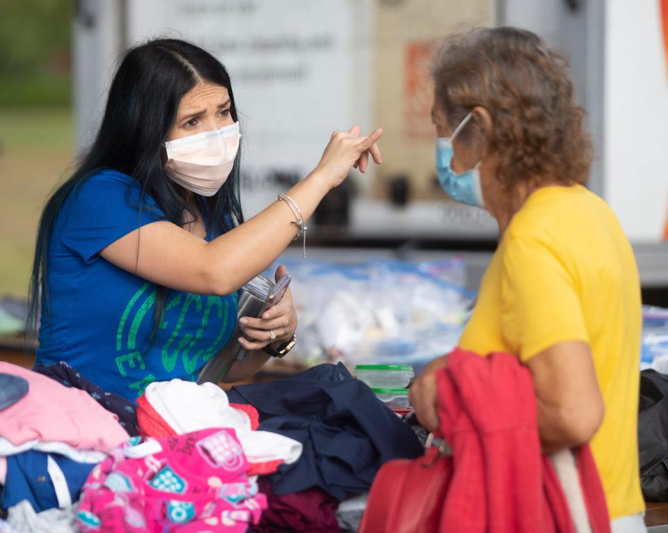 Volunteer Diana Reyes helps folks find clothes at the annual “point in time” homeless survey by the Collier County Hunger and Homeless Coalition on Thursday, Jan. 27, 2022 at Our Lady of Guadalupe Catholic Church in Immokalee, Fla. The survey will continue Friday in East Naples off of Bayshore Drive.