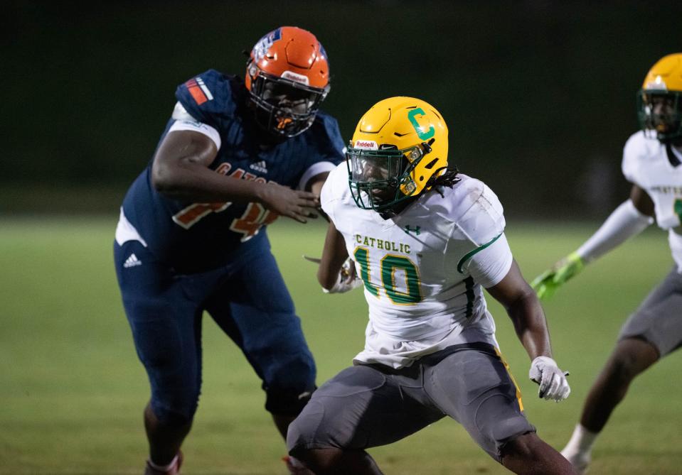 Courtney Clark (10) slips past the offensive line during the Pensacola Catholic vs Escambia football game at Escambia High School in Pensacola on Friday, Sept. 1, 2023.
